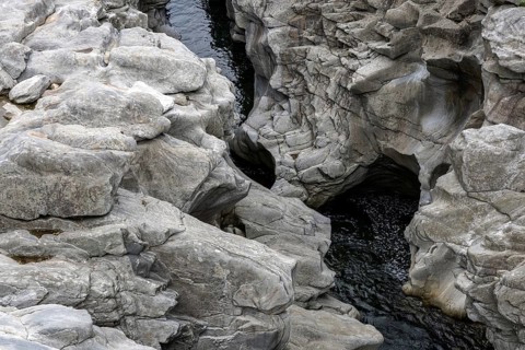 Rocks, granite rock formations in the Maggia River near Ponte Brolla, in the Maggia Valley, Valle