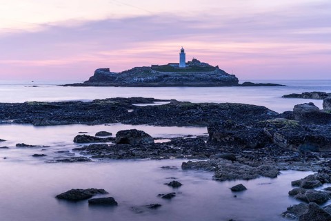 Godrevy Lighthouse, the lighthouse of Godrevy on Godrevy Island. In the evening at sunset. Long