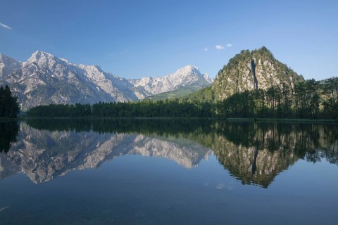 Lake Almsee in summer with totally smooth surface showing reflexion of the mountain Ameisstein