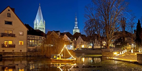 Large pond, St. Patrokli Cathedral and St. Peter's Church in the evening during winter sunshine,