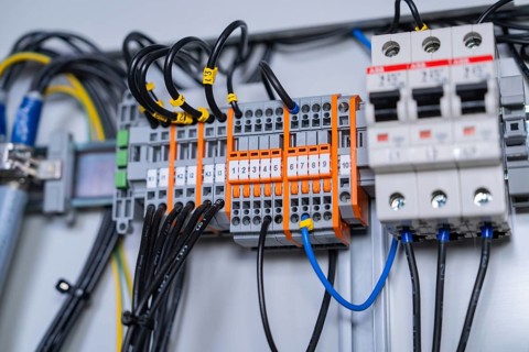 Close-up of wired circuit-breakers, showing technical accuracy and functional arrangement of