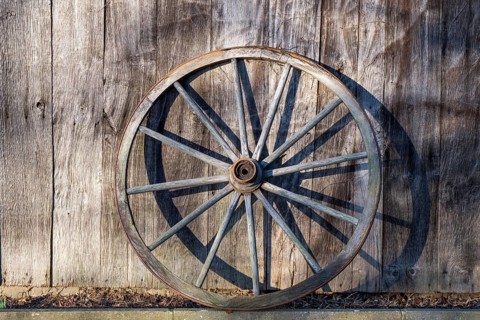 Old wagon wheel leaning against a barn wall, Düstermühle, Legden, district of Wehr, Münsterland,