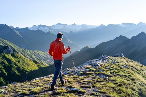Hiker enjoying the mountain panorama in the morning, Venediger group, behind Dreiherrenkopf,