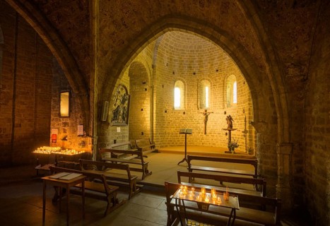 Side chapel with burning candles in the Abbey of Gellone, also Saint-Guilhem-le-Désert Monastery,