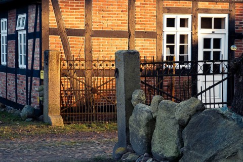 Evening light shines on a driveway and the façade of a half-timbered house, Otersen, Kirchlinteln,