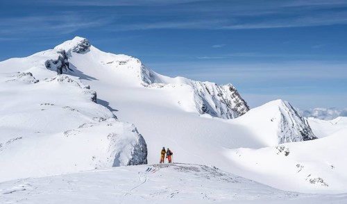 Two ski tourers in front of a snow-covered mountain landscape, Wildhorn in winter, Bernese Alps,