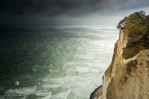 View of the chalk cliffs of Møns Klint on the Baltic Sea in autumn, dark clouds over the stormy