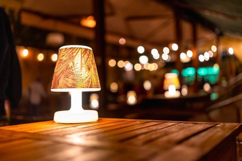 Soft, warm lighting creates a cozy atmosphere at a rustic wedding venue, highlighting elegant