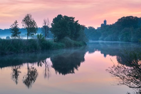 Sunrise at the Saale river with ruins of Schönburg castle, water reflection, morning fog, Naumburg,