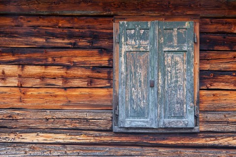 Detailed view of wooden shutters of a hut on an alpine meadow at the foot of the Peitlerkofel,