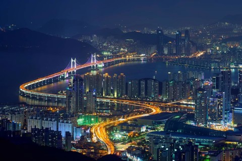 Busan cityscape with skyscrapers and Gwangan Bridge illuminated at night. Busan. South Korea