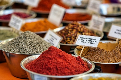 Various spices, tandoori masala at a market stall, multilingual labelling on signs, weekly market