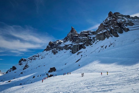 View of a ski resort piste with people skiing in Dolomites in Italy. Ski area Arabba. Arabba,