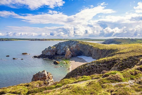 Awesome view at a rocky coastline with a sea bay and heath landscape a sunny summer day, Crozon