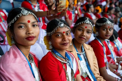 Girls from tea tribe community wearing traditional attire, wait to perform traditional Jhumur