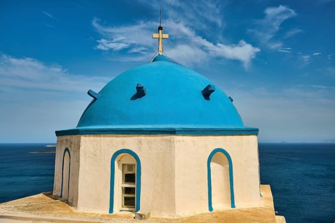 Blue church tower with sea view under a blue sky, Greek architecture, Church of Agios Georgios,