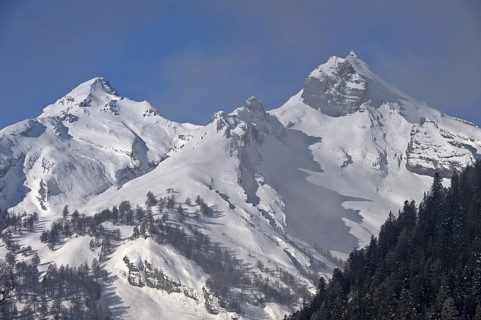 Snow-covered peaks of the Bernese Alps rise out of the fog, Bernese Alps, near Ovronnaz,