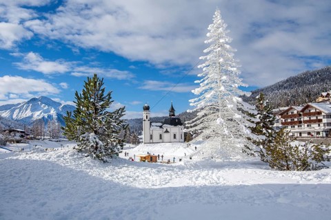 Seekirchl with artificial winter fir tree and Hocheder 2797m in winter, Seefeld, Seefeld Plateau,