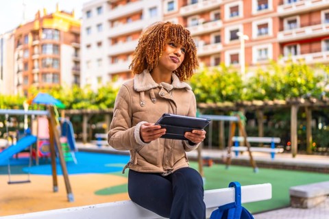 Creative latin young woman working with digital tablet while expressing doubts with face in an