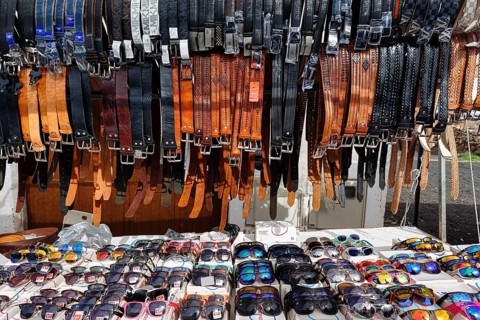 Sunday market, sunglasses and leather belts, souvenirs at a market stall in the old town, Teguise,