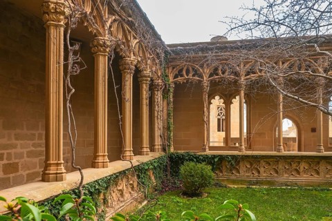 Ivy growing on columns in the gothic style gallery of the palace of the kings of navarre of olite