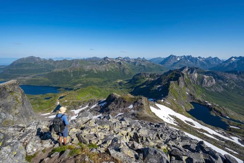 View of mountains and fjord landscape, mountain panorama, mountaineer at the summit of Rundfjellet,