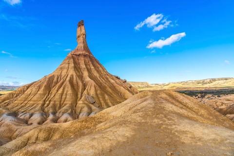 Majestic castildetierra rock formation rising from eroded hills in the bardenas reales desert under