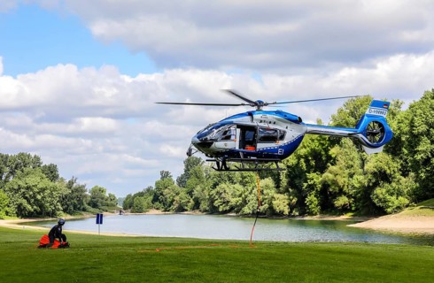 Airbus H 145 police helicopter during an operational exercise with BAMBI BUCKET extinguishing water