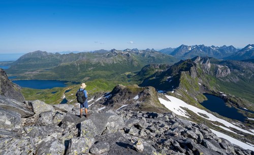 View of mountains and fjord landscape, mountain panorama, mountaineer at the summit of Rundfjellet,