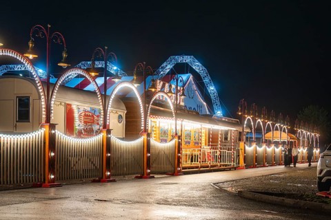 Festively illuminated circus with blue arches and lights that radiate a festive atmosphere,
