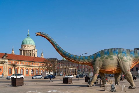 Large figure of a brontosaurus from a dinosaur exhibition in front of the film museum in the