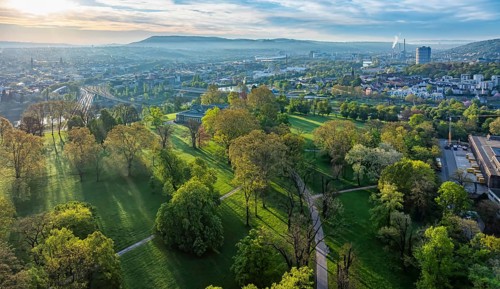 Rosensteinpark in the early morning, view of the cityscape of Bad Cannstatt. Aerial view.