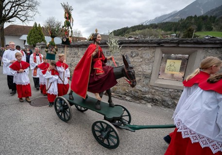 Altar servers preparing for the palm tree procession in the parish church of the Assumption of the