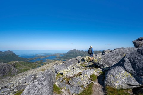 View of mountains and fjord landscape, mountain panorama, mountaineer at the summit of Rundfjellet,