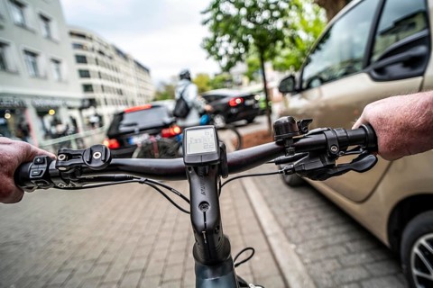 Cycling in the city, inner-city street, cycle lane, bicycles have priority, two-lane traffic with
