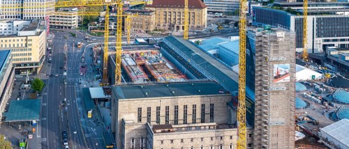 Stuttgart main station with Bonatzbau. Stuttgart 21 construction site with station tower and crane.