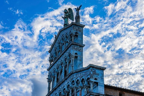 Facade of the church of San Michele in Foro, above the large bronze statue of the Archangel