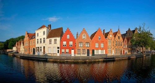 Typical Belgian cityscape Europe tourism concept, panorama of canal and old houses on sunset.
