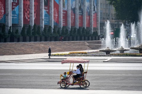 Family in a rickshaw on Ala-Too Square, in Bishkek, Kyrgyzstan, Asia