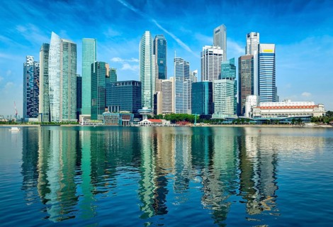 Modern Singapore city skyline of business district downtown in day with reflection in water