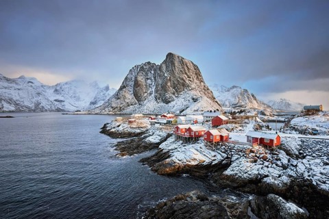 Famous tourist attraction Hamnoy fishing village on Lofoten Islands, Norway with red rorbu houses