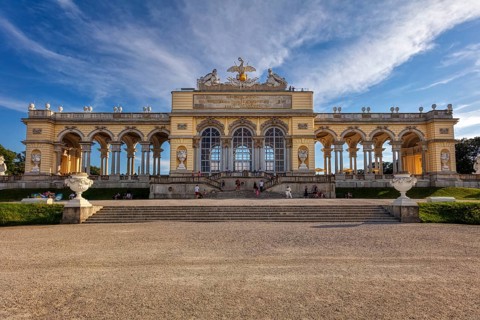 A majestic gloriette with decorative elements and visitors, Vienna
