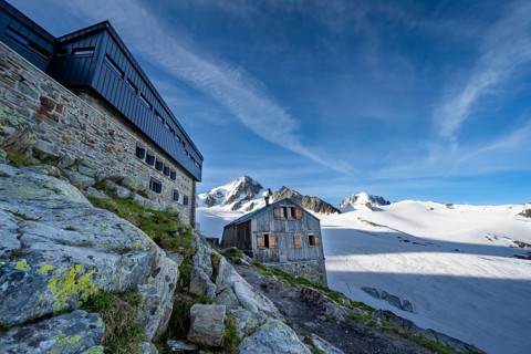 Old and new mountain hut Refuge Albert 1er, high alpine mountain landscape, summit of the Aiguille