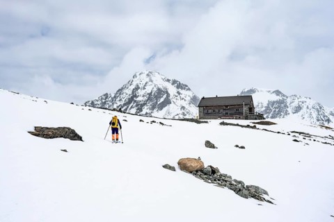 Ski tourer in the mountains in winter, Piz Bever, Chamanna Jenatsch CAS, Swiss Alpine Club hut, Val