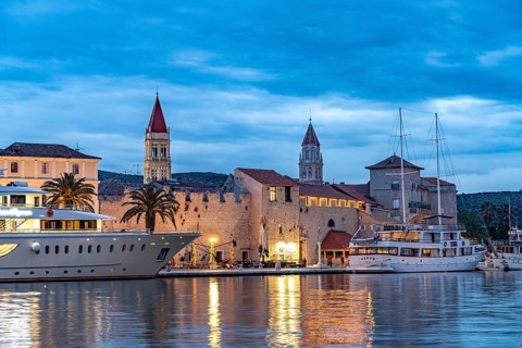 Cruise ships in front of the old town centre of Trogir at dusk, Croatia, Europe