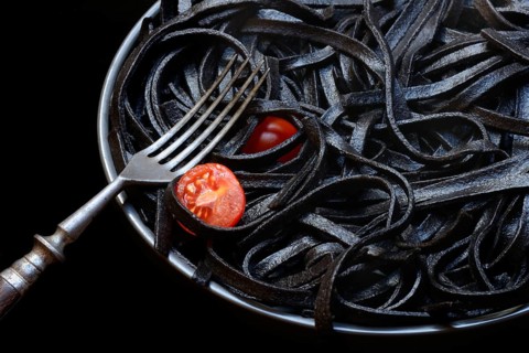 Black pasta coloured with squid ink on a plate, Taglioni al Nero di Seppia, Italy, Europe