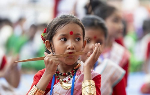 A girl plays Gagana (musical instrument) as she participate in a Bihu dance workshop, ahead of