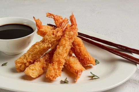 Fried shrimp, peeled in tempura, soy sauce, close-up