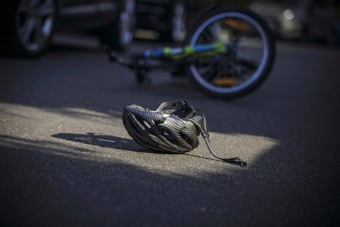 Symbol photo on the subject of bicycle accidents (posed scene) . A broken bicycle helmet lies next