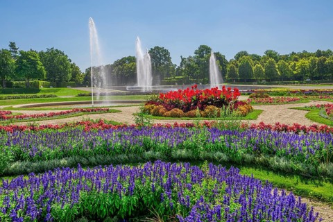 Garden parterre at the New Palace with flowerbeds and fountain in the Schleissheim Palace complex,